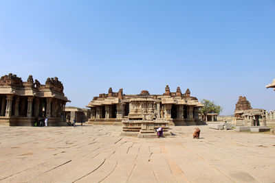 People at temple against sky