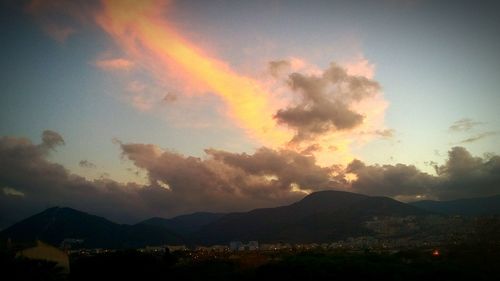 Scenic view of mountains against cloudy sky