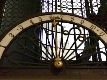 Low angle view of clock on ceiling