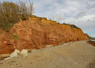 Rock formations on landscape against sky