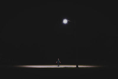 Man against illuminated clear sky at night