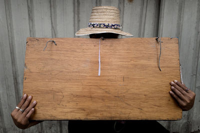 Close-up of hand hanging on wood