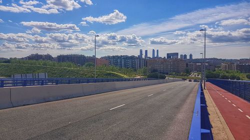 Road by city against sky