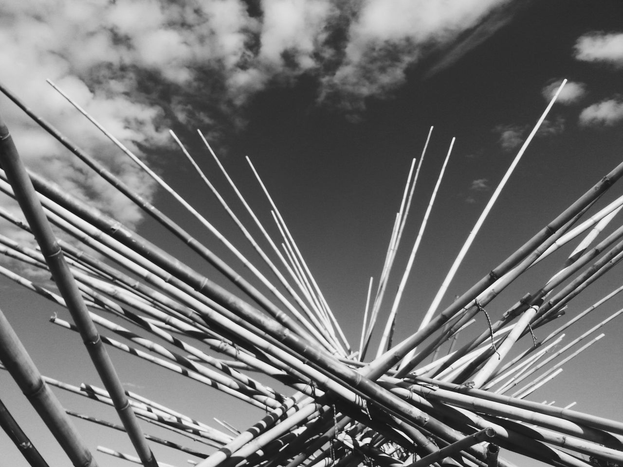 low angle view, sky, built structure, architecture, connection, cloud - sky, outdoors, engineering, no people, cloudy, day, bridge - man made structure, cloud, modern, tall - high, metal, nature, pattern, transportation, city