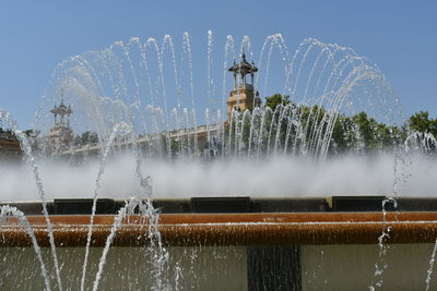 Water splashing in fountain against sky