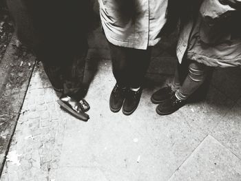 Low section of man standing on tiled floor