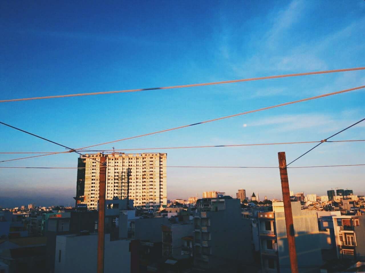 VIEW OF CITYSCAPE AGAINST BLUE SKY