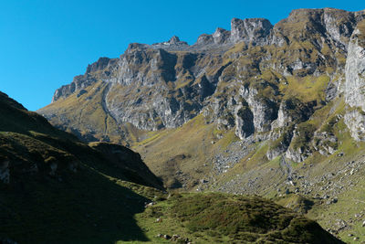 Scenic view of mountains against clear blue sky