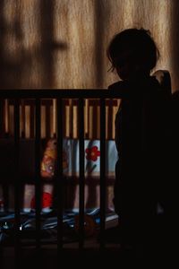 Woman standing against wall at home