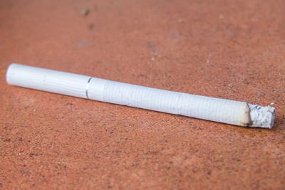 Close-up of cigarette on floor