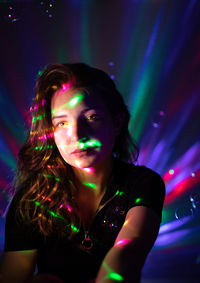 Portrait of woman in illuminated nightclub