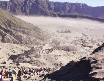 People on landscape against mountain range