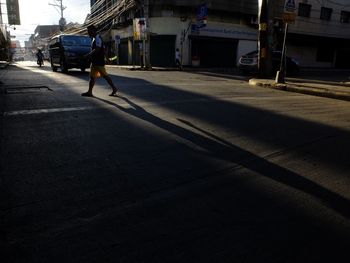 Shadow of man on city street