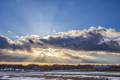 Scenic view of land against sky during sunset