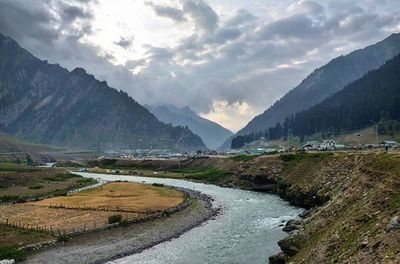 Scenic view of mountains against cloudy sky