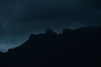 Low angle view of silhouette mountain against sky at dusk
