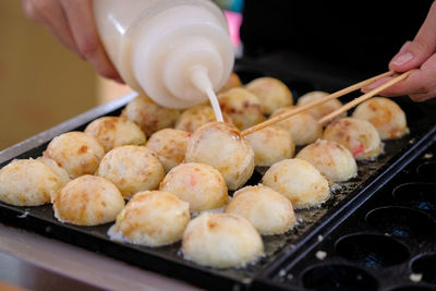 High angle view of person preparing food on tray