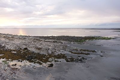Scenic view of beach against sky during sunset