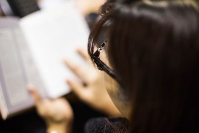 High angle view of woman reading book