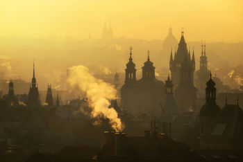 High angle view of silhouette buildings in city against sky during sunset