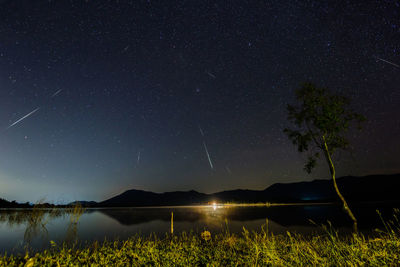 Scenic view of lake against star field at night