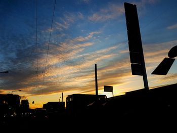 Silhouette road against sky during sunset