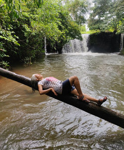 Portrait of young woman sitting in water