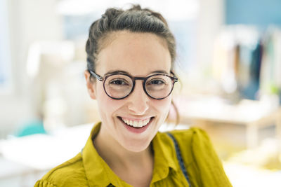 Portrait of happy young woman wearing glasses