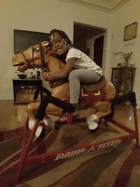 Young man sitting in room