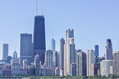 Skyscrapers in city against blue sky