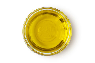 Directly above shot of yellow glass against white background