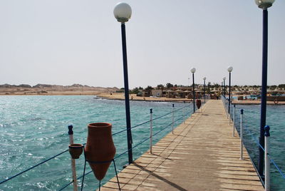 Pier over sea against clear sky