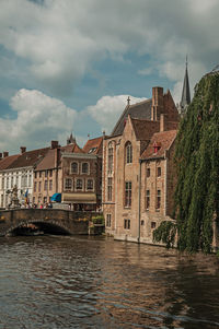 Bridge and old buildings on canal at bruges. a town full of canals and old buildings in belgium.