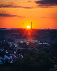 High angle view of townscape against orange sky