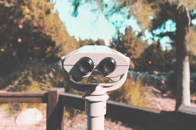 Close-up of coin-operated binoculars against sky