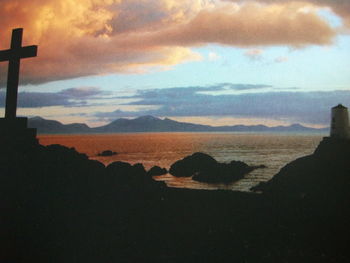 Scenic view of sea and mountains against sky