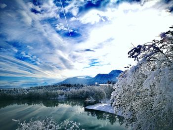 Low angle view of frozen river against cloudy sky