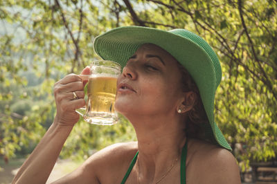 Portrait of woman drinking glasses outdoors