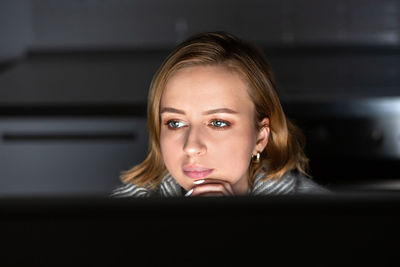Close-up of woman using computer at home