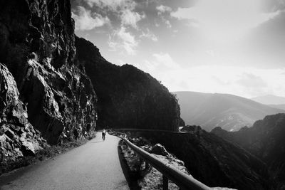 Road amidst mountains against sky