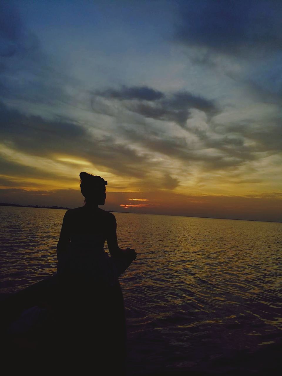 sunset, sky, water, sea, cloud - sky, horizon, one person, beauty in nature, leisure activity, scenics - nature, silhouette, horizon over water, tranquility, real people, nature, sitting, tranquil scene, lifestyles