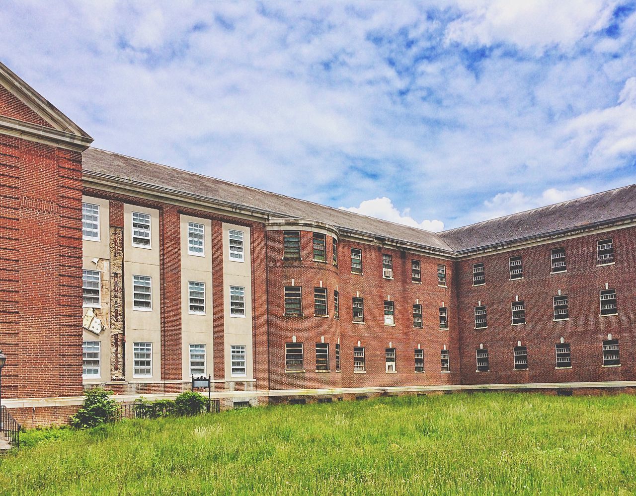 architecture, building exterior, grass, built structure, sky, field, grassy, cloud - sky, lawn, green color, house, window, day, outdoors, old, facade, residential structure, cloud, no people, plant