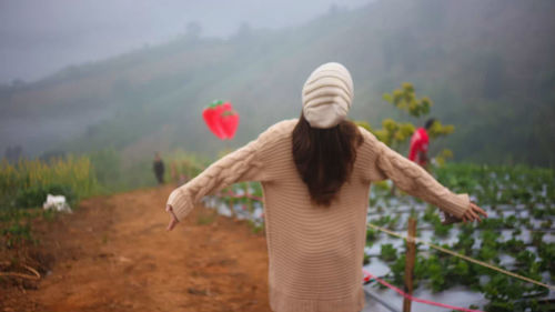 Rear view of woman standing outdoors