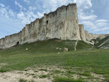 Low angle view of castle on field against sky