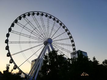 Low angle view of ferris wheel against sky