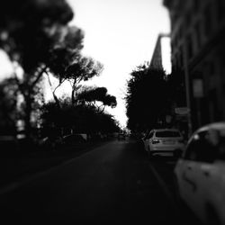 Close-up of cars on road in city