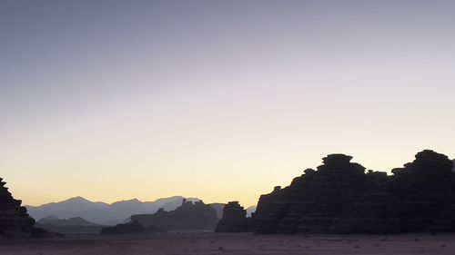 Silhouette of temple against clear sky during sunset