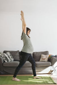 Pregnant woman exercising at home