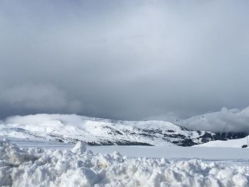 Scenic view of snow covered mountains against sky