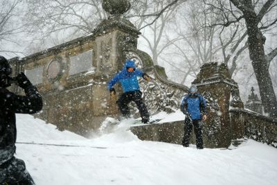 People walking on snow covered landscape